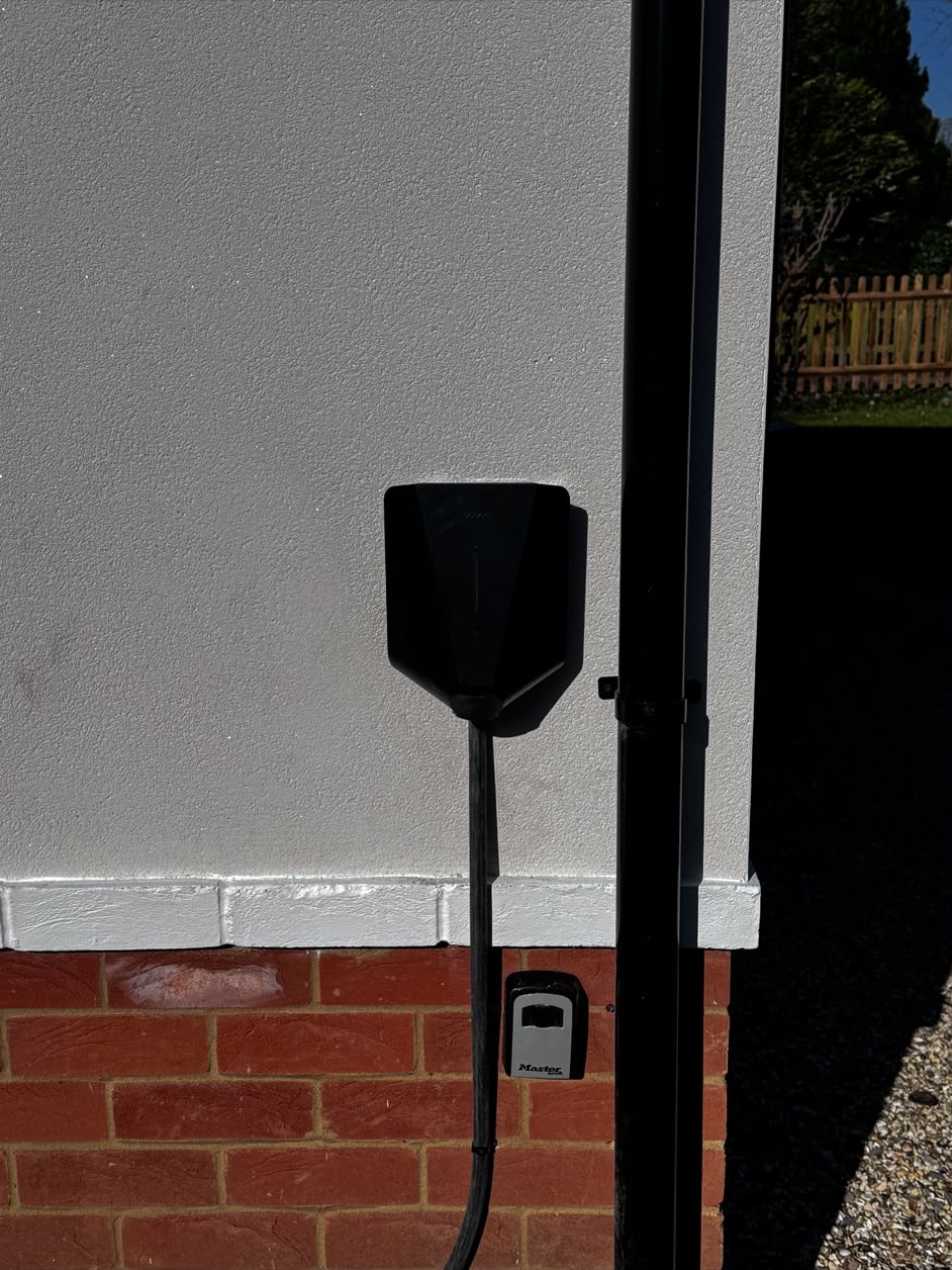 Exterior wall-mounted EV charge point and outdoor electrical supply installed on a Hampshire property