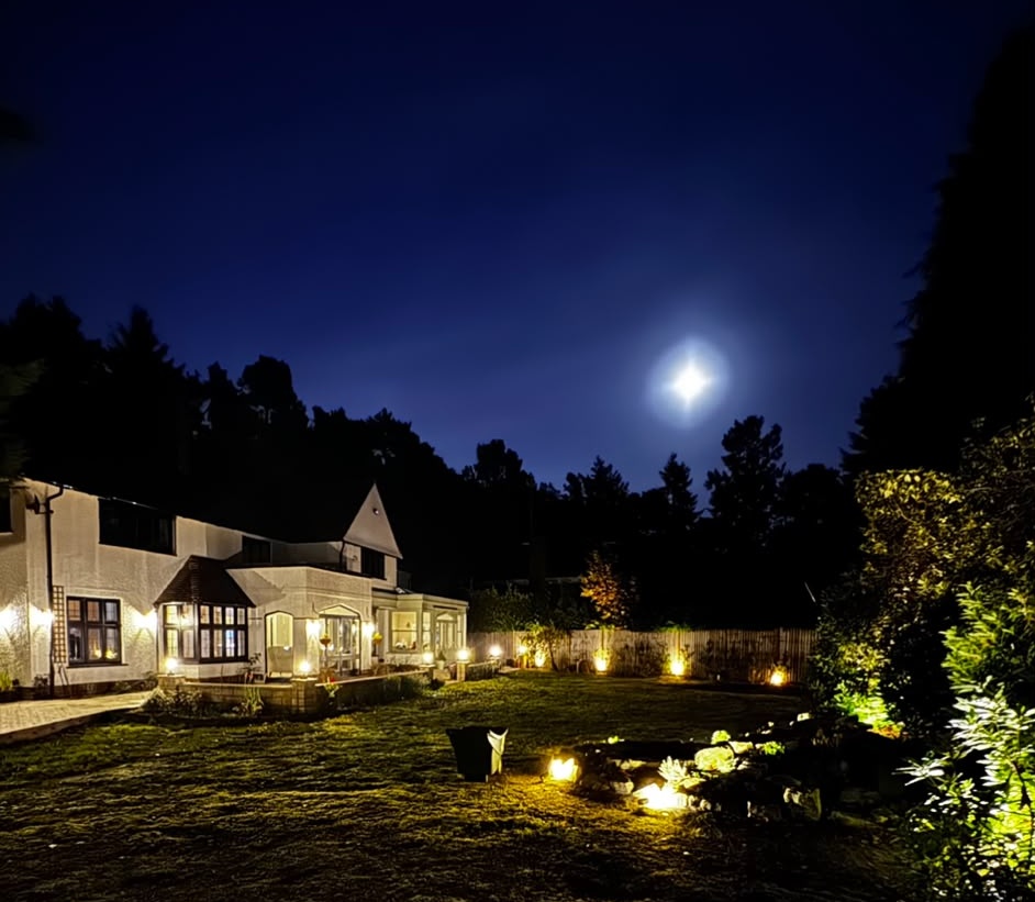 Garden lighting and outdoor electrics illuminating a lawn and patio at night in Fleet, Hampshire